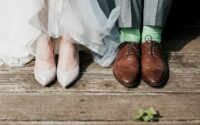 two people standing on brown wooden floor